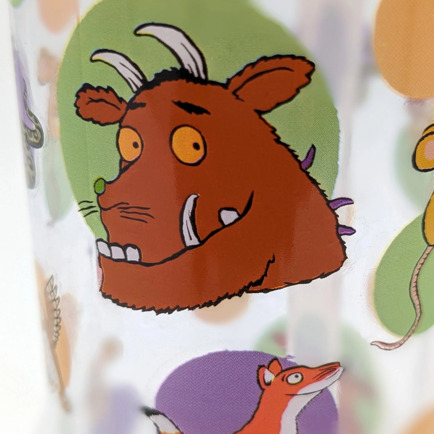 Cartoon character with a brown face and horns on a colorful background