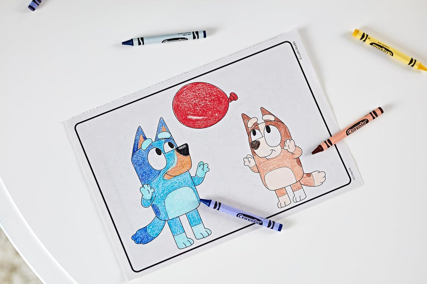 Close-up of Bluey colouring scenes with muddy puddles and family fun