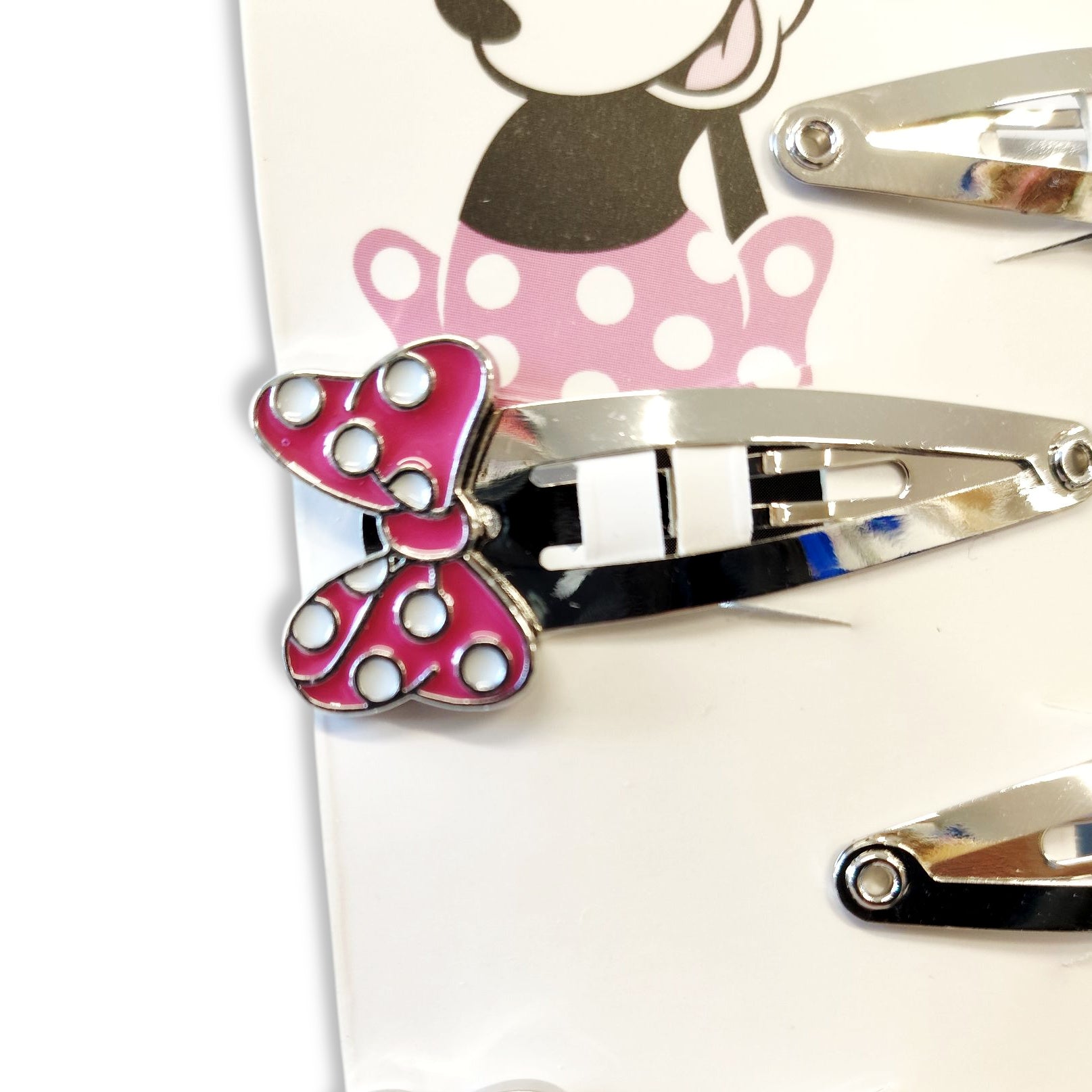 Close-up detail of a Minnie Mouse face enamelled hair clip, showcasing signature ears, cheeks, and vibrant colours